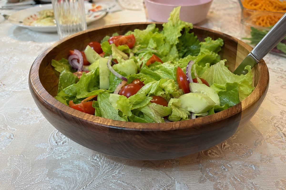 Olive-wood bowl with a fresh salad